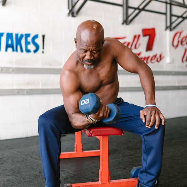A man focused during a complex balance and strength exercise.
