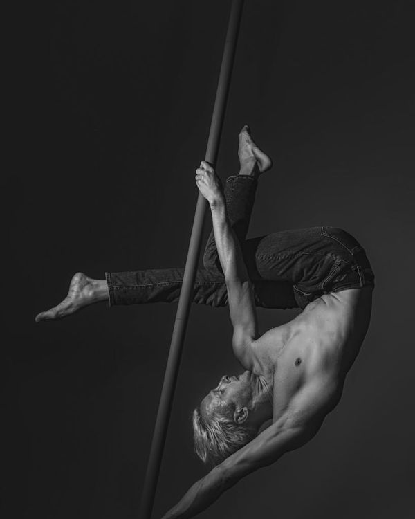 Man performing a controlled strength exercise in a minimalist gym.